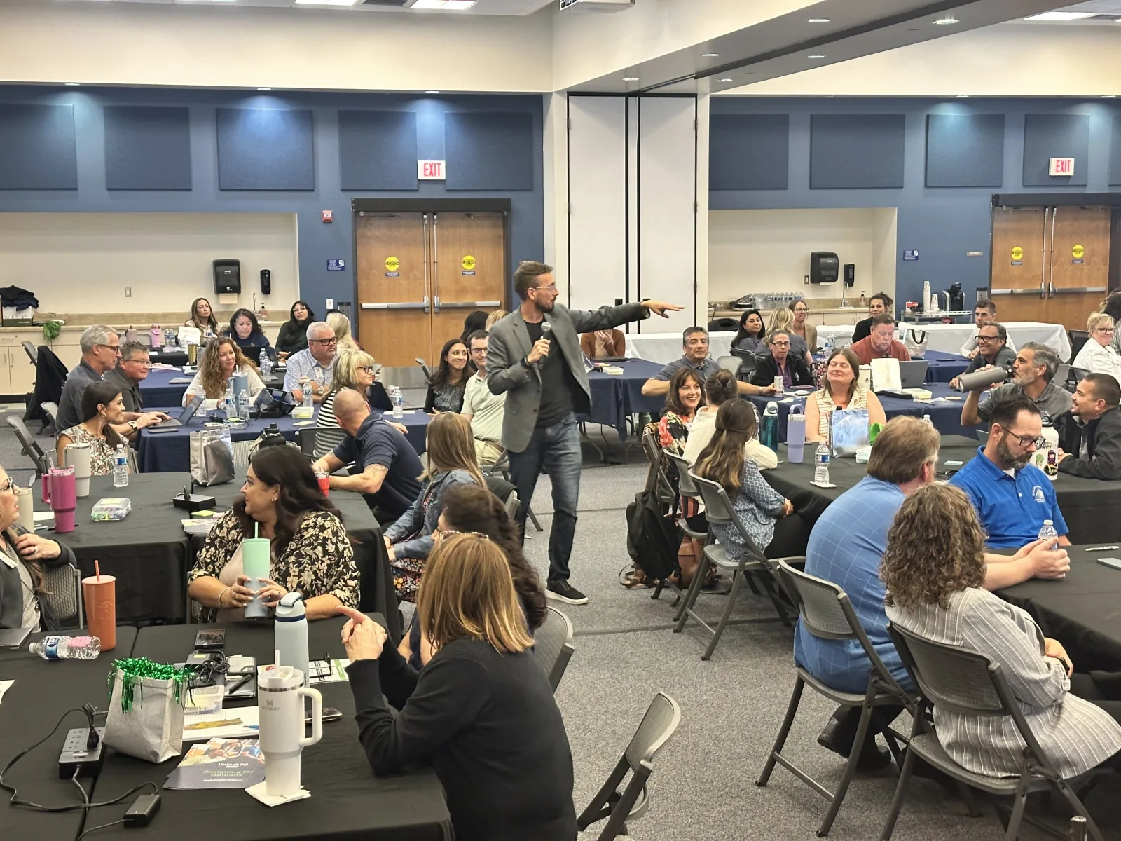 Facilitator walking a room of district leaders through results